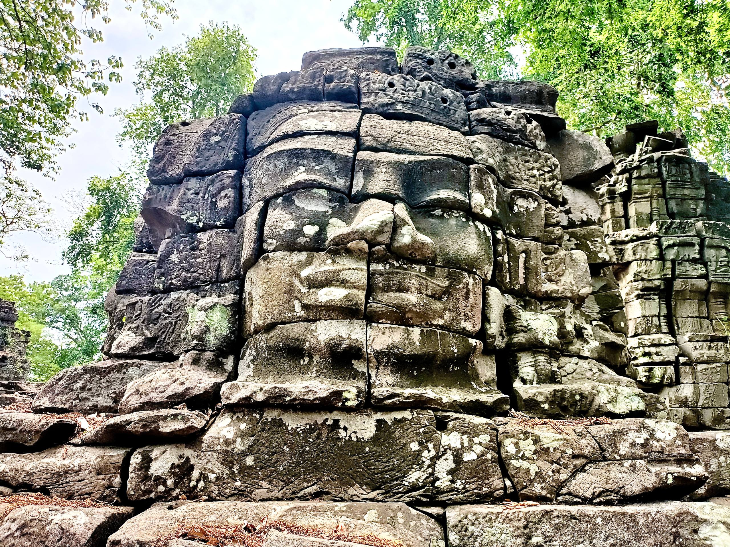 Ancient Buddha face carving at Banteay Chhmar Temple.
