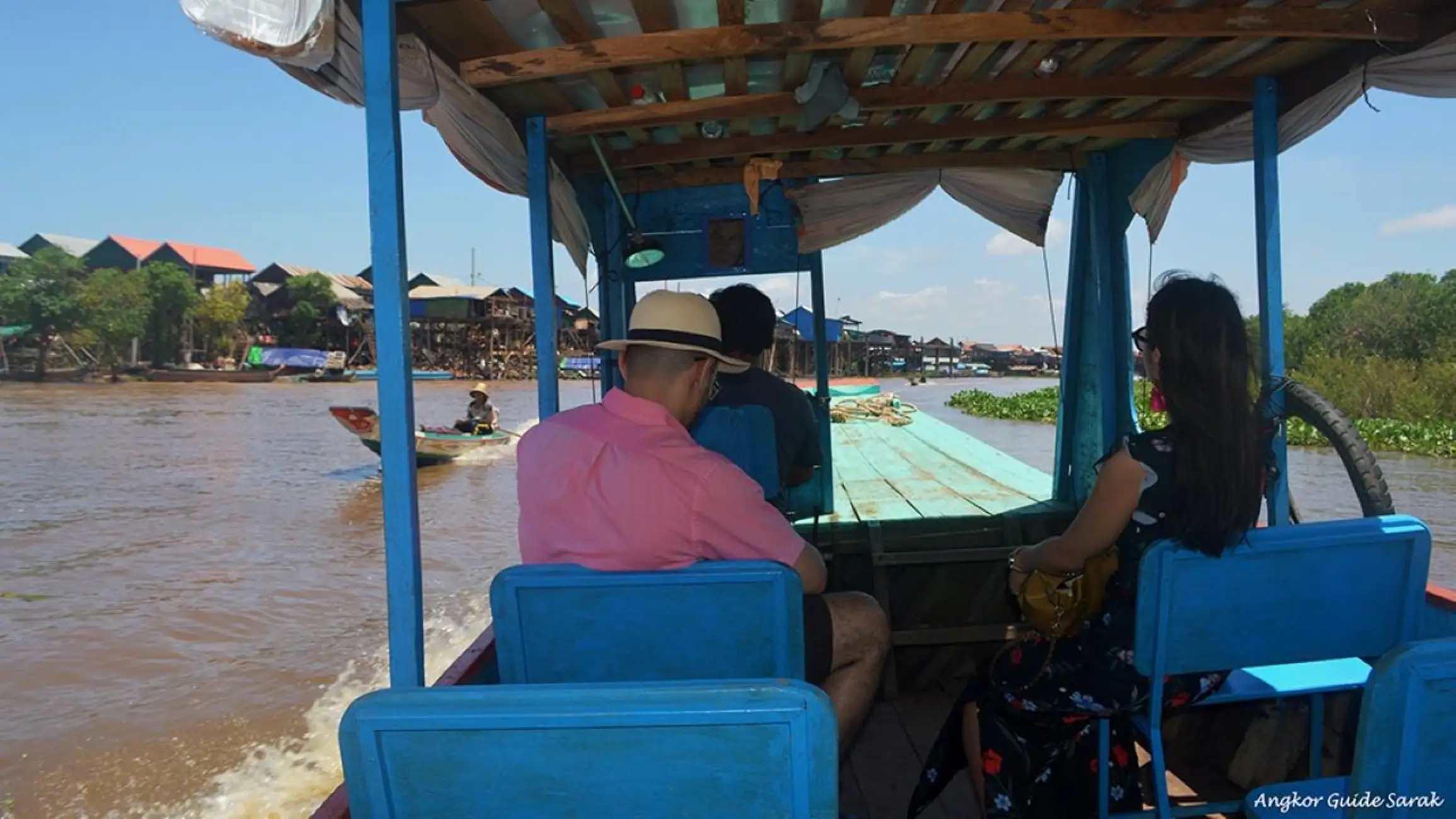 Boat ride through Kampong Phluk Village, passing stilted houses and local fishing communities on Tonlé Sap Lake.