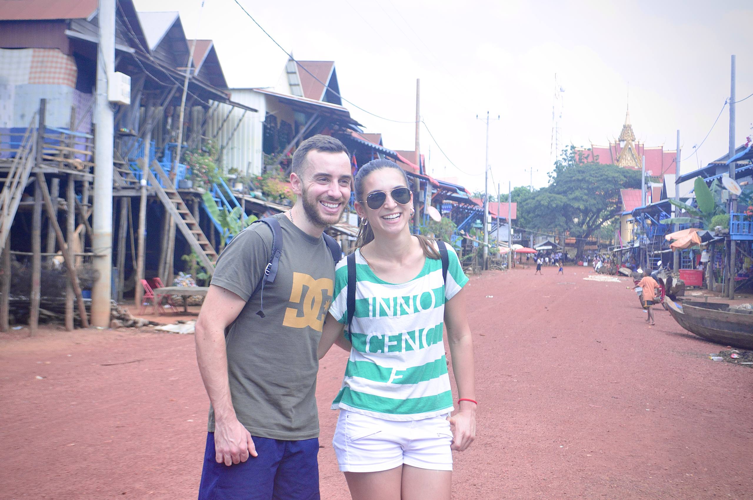 Visitors exploring the charming stilt-house community of Kampong Phluk Village, where local life unfolds along the Tonle Sap Lake.